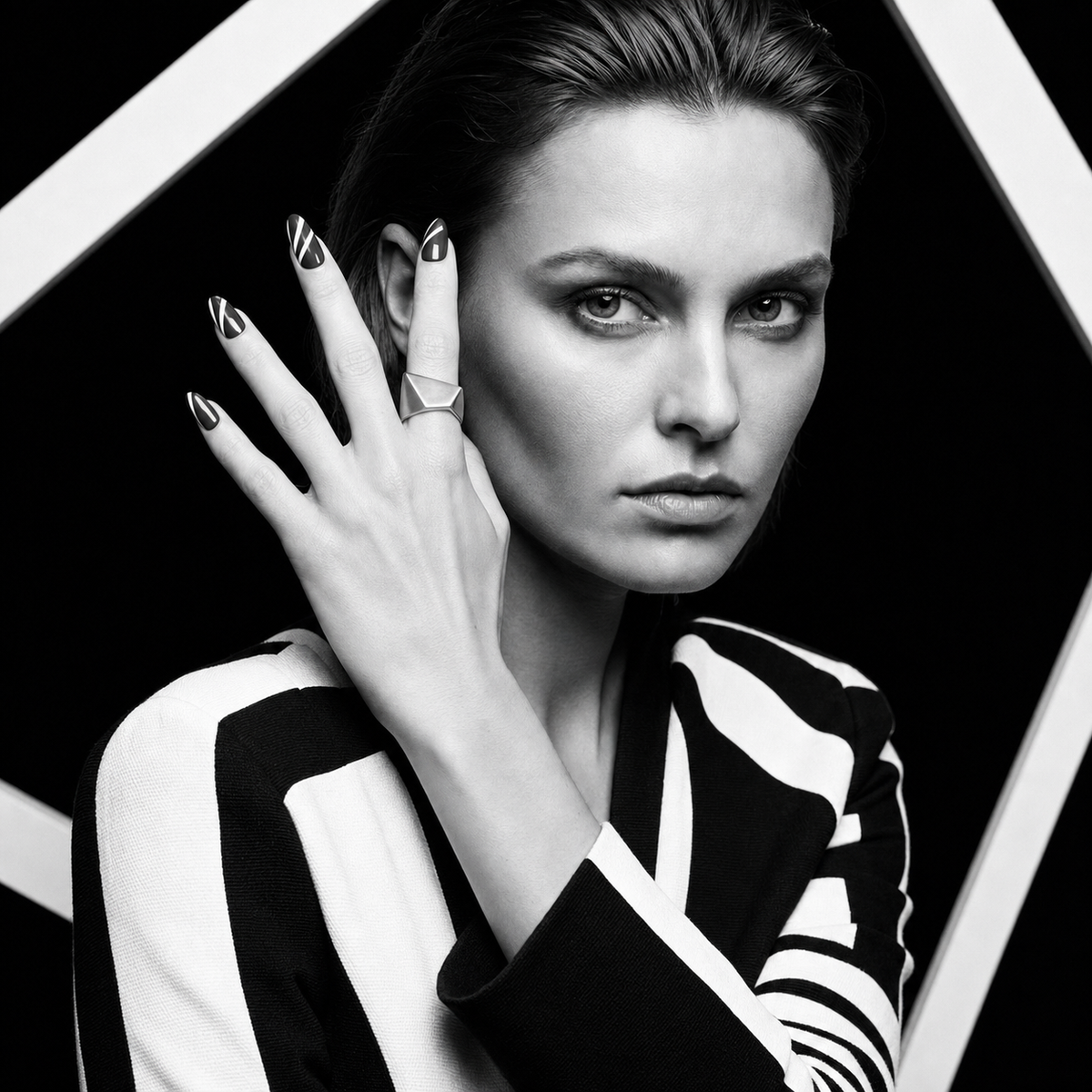 Folded Plane Ring worn in a monochrome editorial portrait